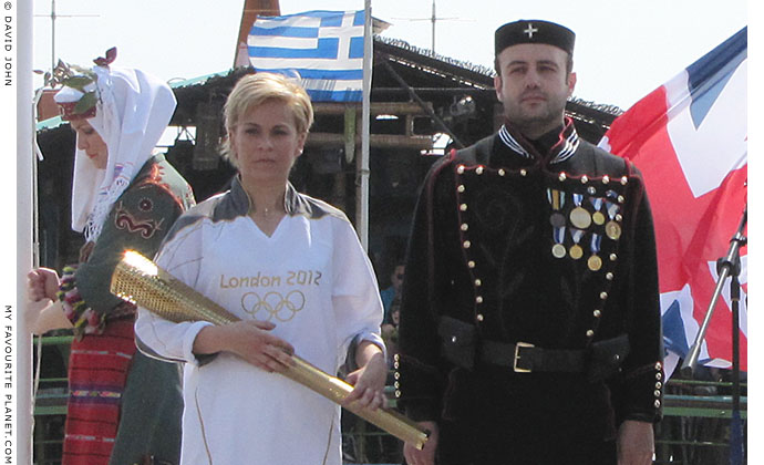 Greek athlete Giota Oikonomou holding her Olympic torch at The Cheshire Cat Blog