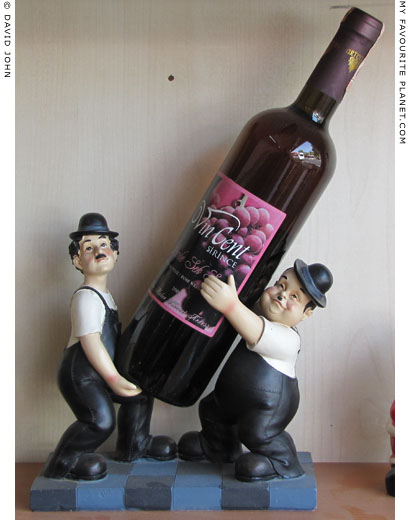 Laurel and Hardy carrying a bottle of Turkish wine in a restaurant in Ephesus, Turkey at The Cheshire Cat Blog