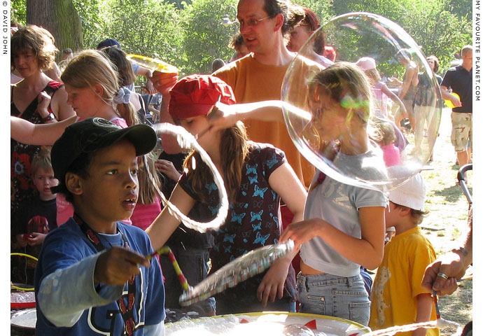 Blowing bubbles at Weltfest am Boxi, by The Cheshire Cat Blog