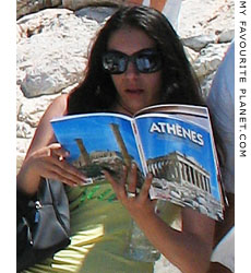Tourist reading a guide book on the Acropolis, Athens at My Favourite Planet