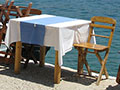Quayside restaurant table in Kastellorizo harbour, Greece at My Favourite Planet