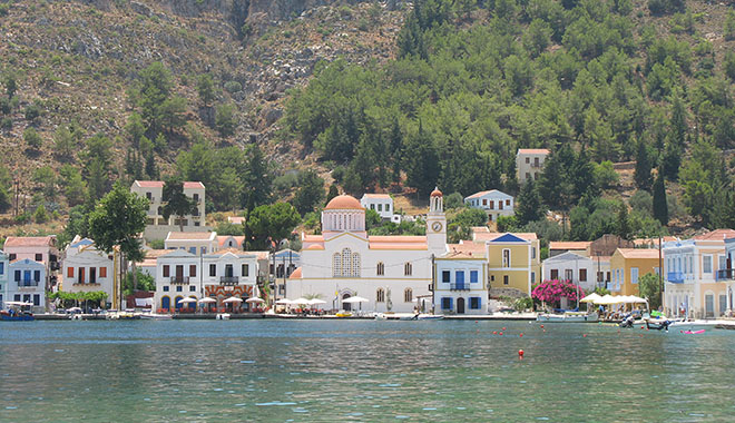 Harbour-side houses and Agios Giorgos Tou Pigadiou church in the centre of Kastellorizo, Greece at My Favourite Planet