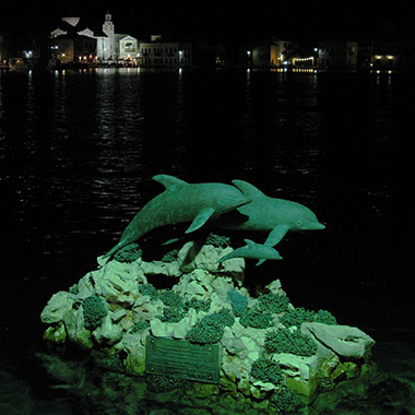 Dolphin sculpture by night, Kastellorizo, Greece at My Favourite Planet