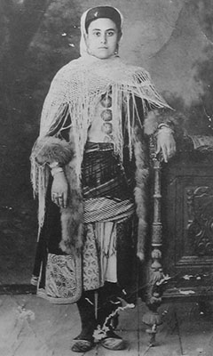 Vintage photo of a young Kastellorizian woman in traditional costume, Kastellorizo Cultural Museum, Greece at My Favourite Planet