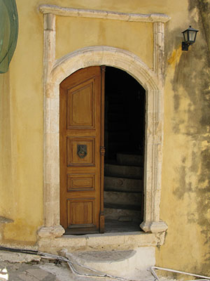 Doorway in a stepped street to the harbour, Kastellorizo town, Greece at My Favourite Planet