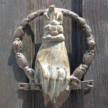 Hand-shaped door knocker of a house on the harbour front, Kastellorizo, Greece at My Favourite Planet