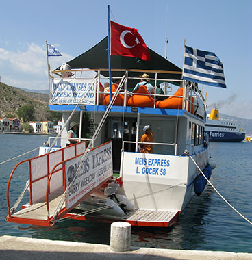 The Turkish and Greek flags fly side by side on the Meis Express ferry in Kastellorizo harbour, Greece at My Favourite Planet