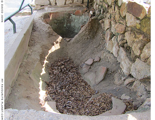The bases of large ceramic storage jars set into the earth.