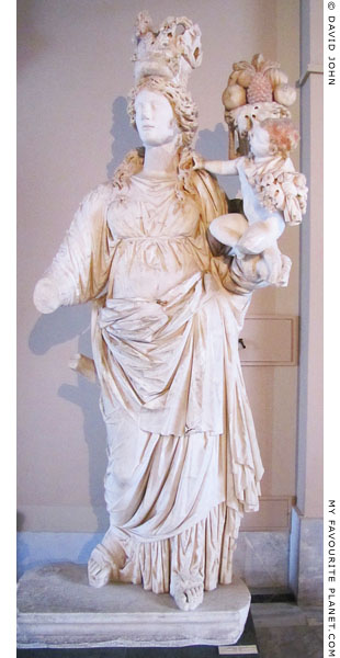 A marble statue of Tyche holding the infant Ploutos and a cornucopia at My Favourite Planet