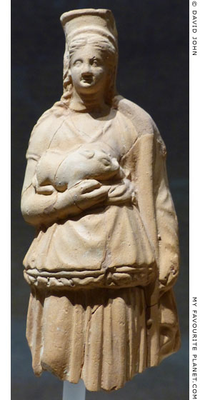 Terracotta female figure holding a piglet at My Favourite Planet