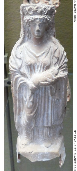 Terracotta figurine of a goddess wearing a polos and holding a piglet from Megara Hyblaea at My Favourite Planet