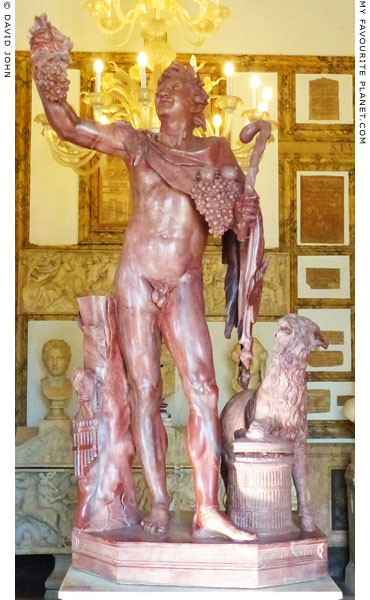 A statue of a Faun and a goat in marmo rosso antico at My Favourite Planet
