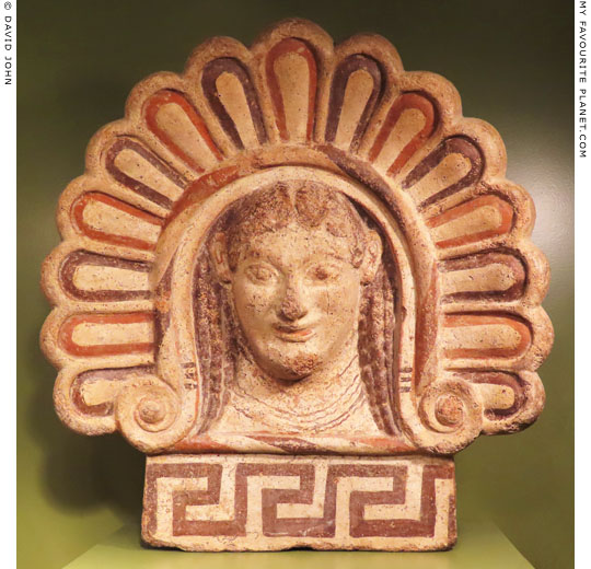 A shell-frame terracotta antefix with the head of a woman at My Favourite Planet