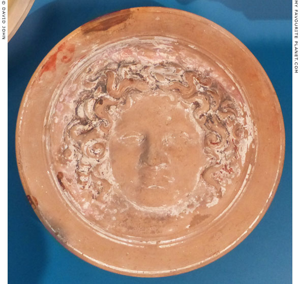 The lid of a terracotta relief pyxis with a Gorgoneion at My Favourite Planet