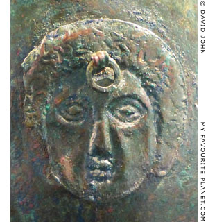 Gorgoneion attachment on a bronze pilos helmet at My Favourite Planet